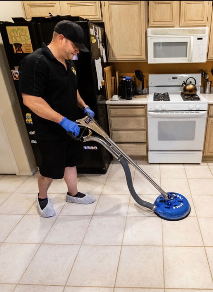 max cleaning tile and grout with his cleaning tool
